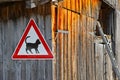 Cat caution sign on barn building with ladder