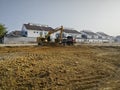 CAT digger moving soil into back of large truck at the new developing construction site Royalty Free Stock Photo