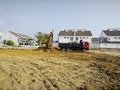 CAT digger moving soil into back of large truck at the new developing construction site Royalty Free Stock Photo