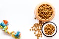 Cat and dog dry food in bowl and toys on white background top view mockup Royalty Free Stock Photo