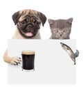 Cat and dog holding fish and beer peeking from behind empty board. isolated on white background Royalty Free Stock Photo