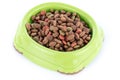 Cat food granules in a green bowl