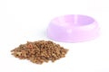 Cat food out of a purple pink bowl isolated on white background Royalty Free Stock Photo