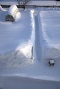 Cat footprints in the snow. The path leading to the house through the snowdrifts. Summer cottage in the snow in the countryside in