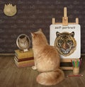 Cat ginger looks in mirror near its self-portrait