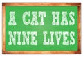 A CAT HAS NINE LIVES words on green wooden frame school blackboard