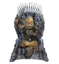 Cat in armor on the iron throne Royalty Free Stock Photo