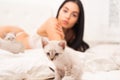 Cat and lady. Play with kitty. Gorgeous attractive girl relax with cute kittens. Woman perfect body and cat. Sexy model