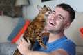 Cat licking owners face at home Royalty Free Stock Photo