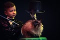 Cat and Magician kid illusionist boy in hat. mystery childhood isolated black background