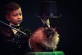 Cat and Magician kid illusionist boy in hat. mystery childhood black background