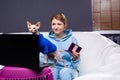 Cat owners woman with pet passport in front of laptop pc at home. Veterinary animal digital identification, modern technology. Pet Royalty Free Stock Photo