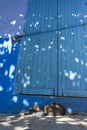 Cat resting in front of a door, in the street, all blue painted, in the medina of Chefchaouen, Morocco Royalty Free Stock Photo