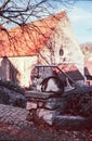 A cat resting on a stone in front of the church of the medieval Swiss town of Kaiserstuhl, shot with analogue film photography