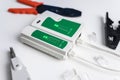 Cat6 RJ45 cable network tester. Twisted pair test tool on the desktop Royalty Free Stock Photo