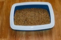 Cat`s litter box with filler on floor Royalty Free Stock Photo