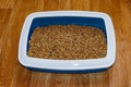 Cat`s litter box with filler on floor Royalty Free Stock Photo