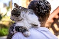 A cat on the shoulders of an elderly woman, cute photo.