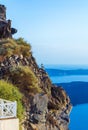 Cat sits on the cliff edge of Santorini Caldera scenic view Greece Royalty Free Stock Photo