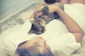 Cat sleep on asian woman chest on carpet