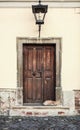 Cat sleeping on the steps in front of old door