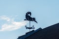 Cat vane on the roof on blue sky background Royalty Free Stock Photo