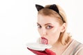 Cat woman eat sour cream. Dieting and health. cat woman lick milk from plate. Food and drink. Ecology product and Royalty Free Stock Photo