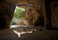 Catacomb entrance and inner part with tree and tied pieces of cl