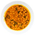 Stewed curried chickpeas with spinach on white plate