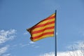 Catalan Senyera flag against a blue sky