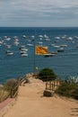 Catalan flag with sea and boats in the background.