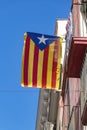 Catalan independence flag hanging from a window demanding the independence of Catalonia