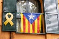 Catalan independence flag and yellow ribbon hanging from a window demanding the independence of Catalonia and the freedom of the