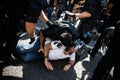 A catalan riot police detaining a protester