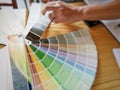 Catalogue of colour with hand of man selecting for interior design