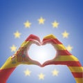 Catalonia Estelada flag and Spain flag on Catalunya people`s heart-shape hands or Catalonia- Spanish unity supporter on EU