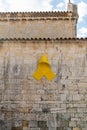 Spanish Catalonian yellow ribbon symbol for independance on the old stone wall of a cathedral