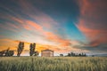 Catalonia, Spain. Spring Sunset Sky Above Spanish Countryside Rural Wheat Field Landscape. Lonely Barn Farm Building