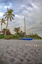 Catamaran boat at sunrise on a white sand beach Royalty Free Stock Photo