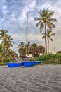 Catamaran boat at sunrise on a white sand beach Royalty Free Stock Photo