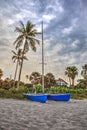 Catamaran boat at sunrise on a white sand beach Royalty Free Stock Photo