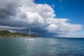Catamaran by the coastline over dramatic sky Royalty Free Stock Photo