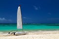 Catamaran on the exotic coast of the Atlantic Ocean with a background from golden sand of emerald water and the blue sky. Royalty Free Stock Photo