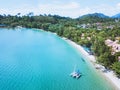 Catamaran with sail anchored on beautiful tropical beach