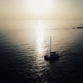 Catamaran sailboat on the calm ocean in the Bahamas at sunset