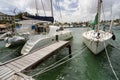 Catamaran and a sailboat moored at the port of Aruba