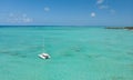 Catamaran sailing boat in turquoise sea lagoon on tropial Mauritius island. Aerial, drone view.