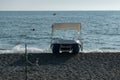 Catamaran on the seashore. Waves of the sea surf on the stone beach. Royalty Free Stock Photo