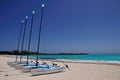 Rental Catamarans parked on a white beach.