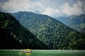 Catamarans on Lake Ritsa in Abkhazia. Walks on the water. Ecologically clean place in the mountains.